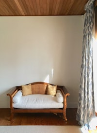 a wooden couch in a room with a wooden ceiling