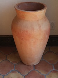 a large pot sitting on a tile floor