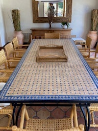 a dining room with a blue tiled table and chairs